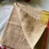 Devika – Sandalwood Beige Gold Zari Red Border Mulmul Saree