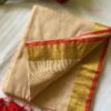 Devika – Sandalwood Beige Gold Zari Red Border Mulmul Saree